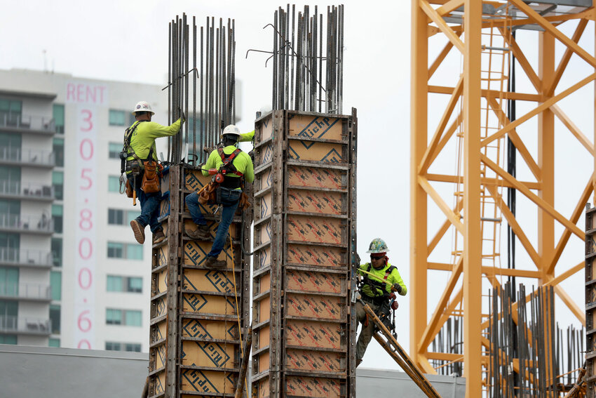 MIAMI, FLORIDA - OCTOBER 02: Construction workers build a residential high rise on October 02, 2023 in Miami, Florida.  According to the Census Bureau, apartment building starts fell to a seasonally adjusted annual rate of 334,000 units in August, marking a 41% decline from the pace seen the same month a year prior.