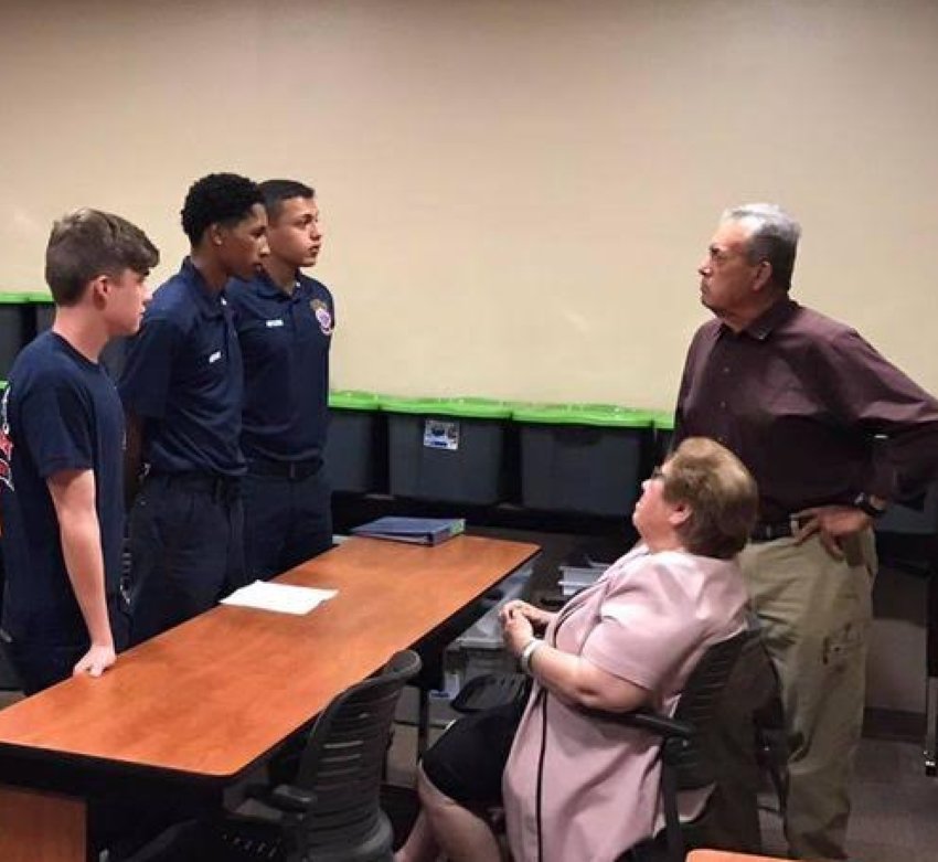 AFD recruits Josh Bolander, Xavier Spry, and William Ayala (left) talk to Mr. and Mrs. Borjas (right)