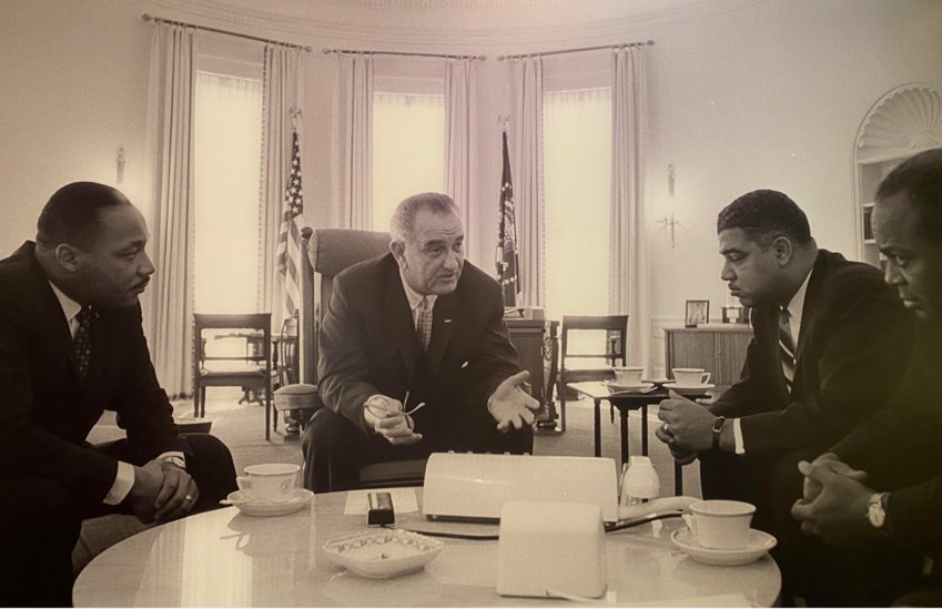 Dr. Martin Luther King Jr sits with President Lyndon B. Johnson at the White House.