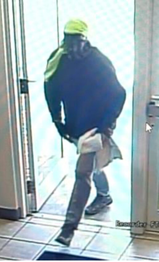 The suspect (pictured above) entered the bank, walked behind the teller counter, and removed money from an open drawer before fleeing the scene on foot.