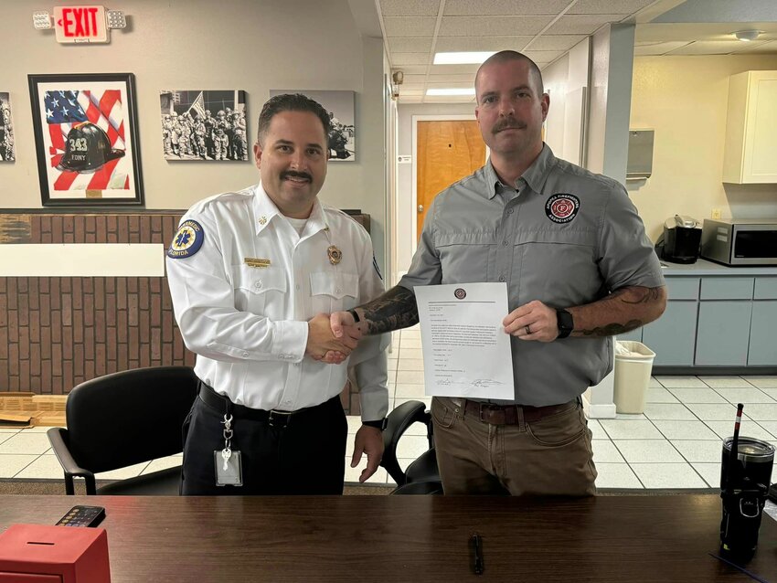 Apopka Interim Fire Chief Wil Sanchez and Apopka Professional Firefighter Association President Alex Klepper shake hands after the contract takes the next step in the ratification process.