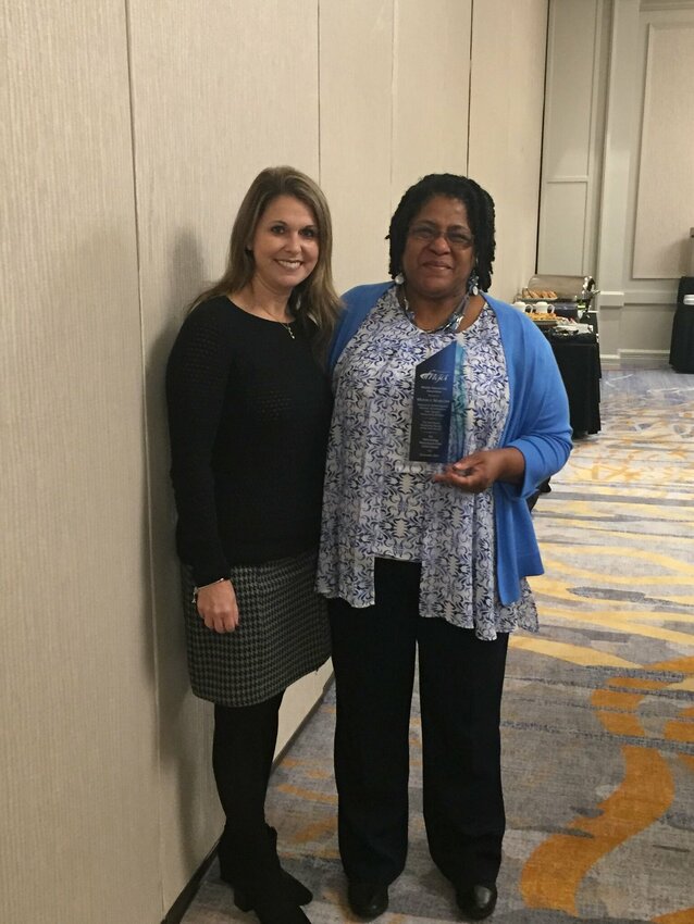 Monica Marlow (right) receives an award from the Florida Natural Gas Association as the 2017 Marketing Person of the Year.
