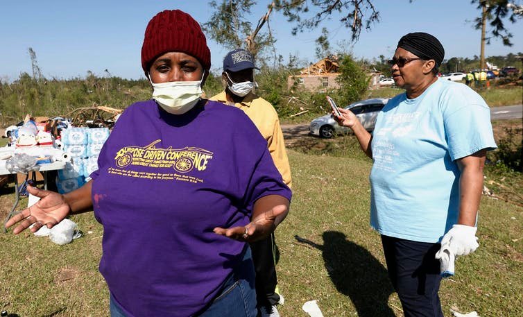 When deadly tornadoes struck the Southeast in April, residents in Prentiss, Mississippi, struggled to keep up coronavirus precautions while salvaging what they could from their damaged properties.&nbsp;AP Photo / Rogelio V. Solis