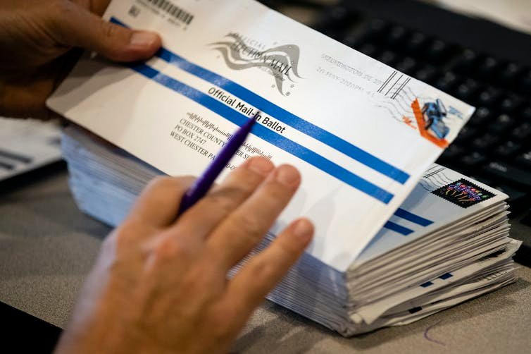 An election worker processes mailed-in ballots for a state's primary election in 2020. AP Photo/Matt Rourke