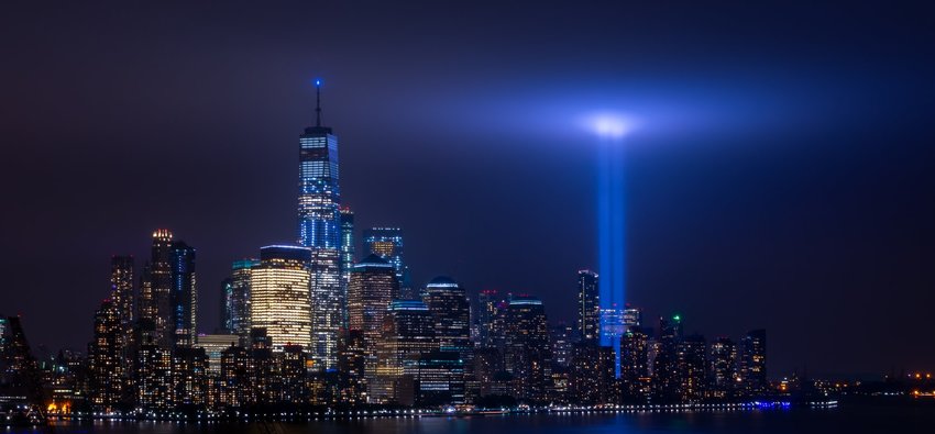 Photo of New York City with 9/11 Memorial lights, by Jesse Mills on Unsplash