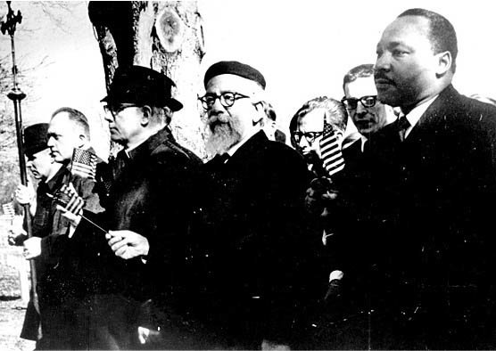 In 1965, Martin Luther King, Jr., and Abraham Joshua Heschel walked side-by-side from Selma to Montgomery in protest of segregation and voter suppression. Photo from the Library of Congress.