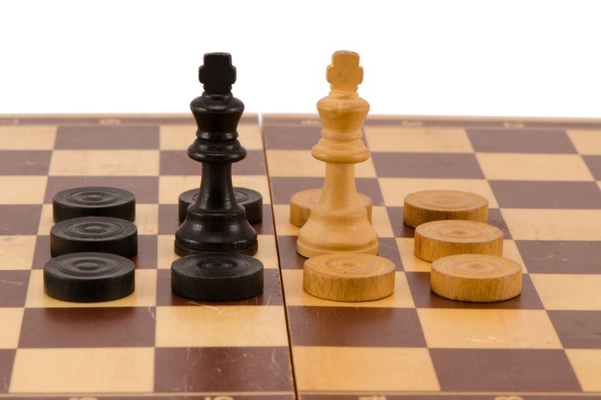 http://www.dreamstime.com/stock-images-enemy-chess-queen-surround-checkers-board-isolated-image28879304