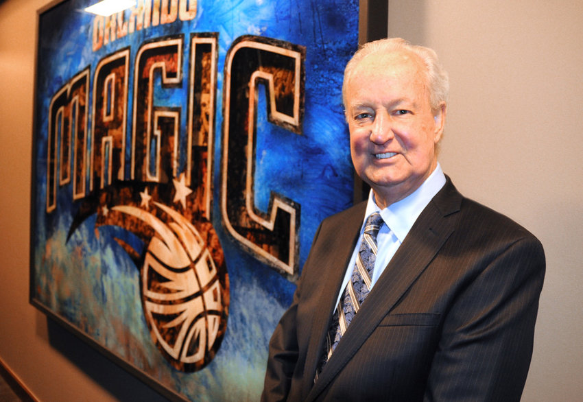 Pat Williams stands by an Orlando Magic mural at the Amway Center. JIM CARCHIDI