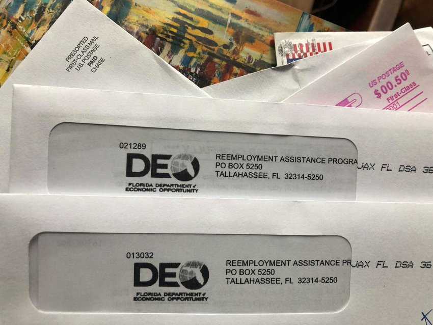 Envelopes from the Florida Department of Economic Opportunity Reemployment Assistance Program are shown, Thursday, Nov. 5, 2020, in Surfside, Fla. - AP Photo/Wilfredo Lee