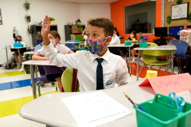 In this Monday, Aug. 23, 2021, file photo, student Winston Wallace, 9, raises his hand in class at iPrep Academy on the first day of school in Miami. AP Photo / Lynne Sladky, File