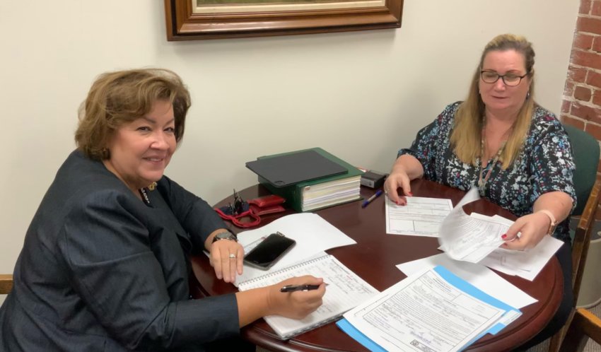 Commissioner Diane Velazquez (left) completes her qualifying documents to run for re-election to Seat #2 on the Apopka City Commission with Apopka City Clerk Susan Bone (right).