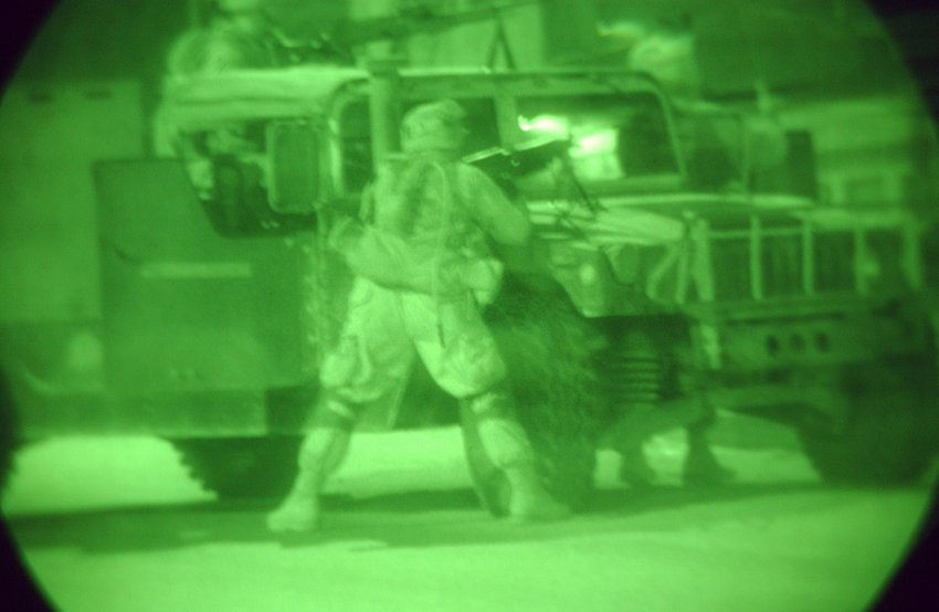 Light enhanced night vision photography showing US Marine Corps (USMC) Marines assigned to A/Company, Battalion Landing Team (BLT) 1st Battalion, 4th Marine Regiment, 11th Marine Expeditionary Unit (MEU) Special Operations Capable (SOC), use a High-Mobility Multipurpose Wheeled Vehicle  (HMMWV) equipped with a 7.62mm M240G machine gun, to respond with deadly and accurate fire to an ambush set by Anti-Iraqi Forces in An Najaf, Iraq, during Operation IRAQI FREEDOM II. (SUBSTANDARD)