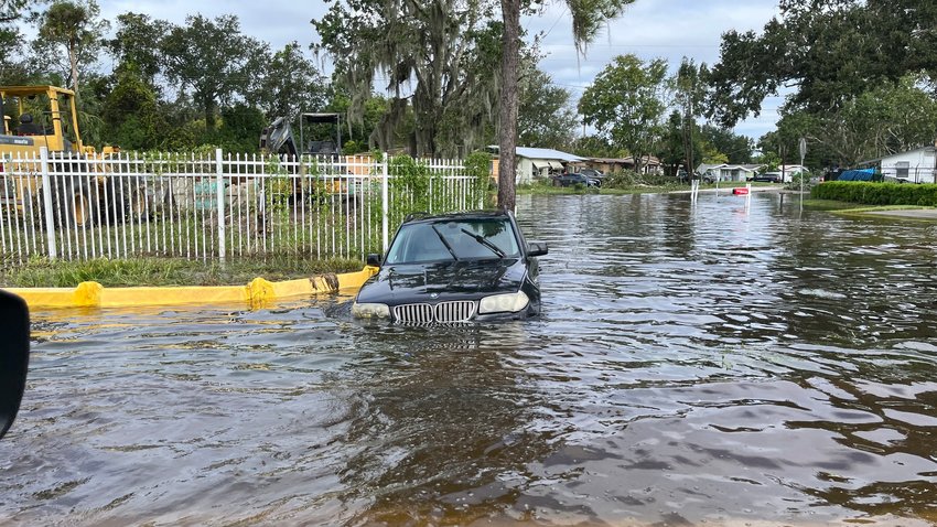 Picture of a submerged BMW in the street after Hurricane Ian.