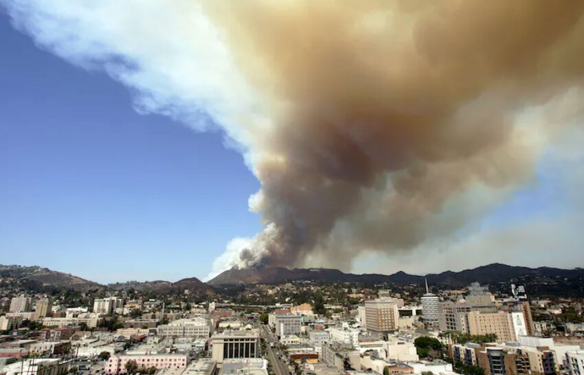 Smoke rises from a brush fire near Hollywood Hills in Los Angeles.