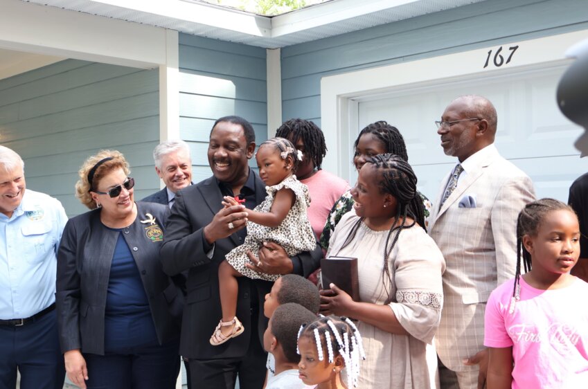 Friends, family, and elected officials celebrated with the new homeowners.
