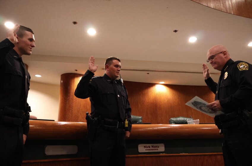 Apopka Police Chief Michael McKinley swears in two new officers.