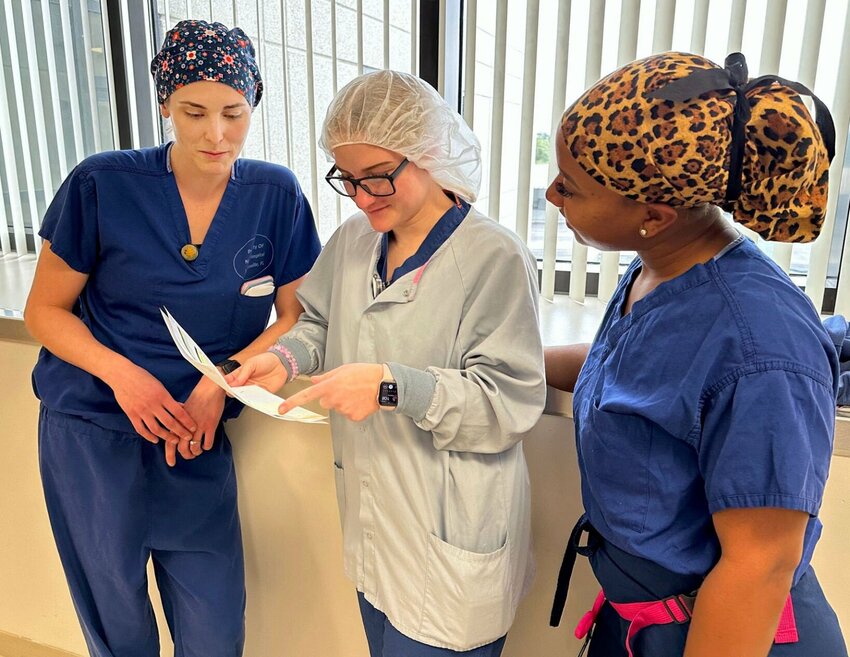 Lt. Candace Stover, left, a perioperative nurse at Naval Hospital Jacksonville, reviews the day’s schedule for the operating rooms with Hospital Corpsman 3rd Class Hayley Widows and Lt. Kendall Lee on Nov. 3, 2023.