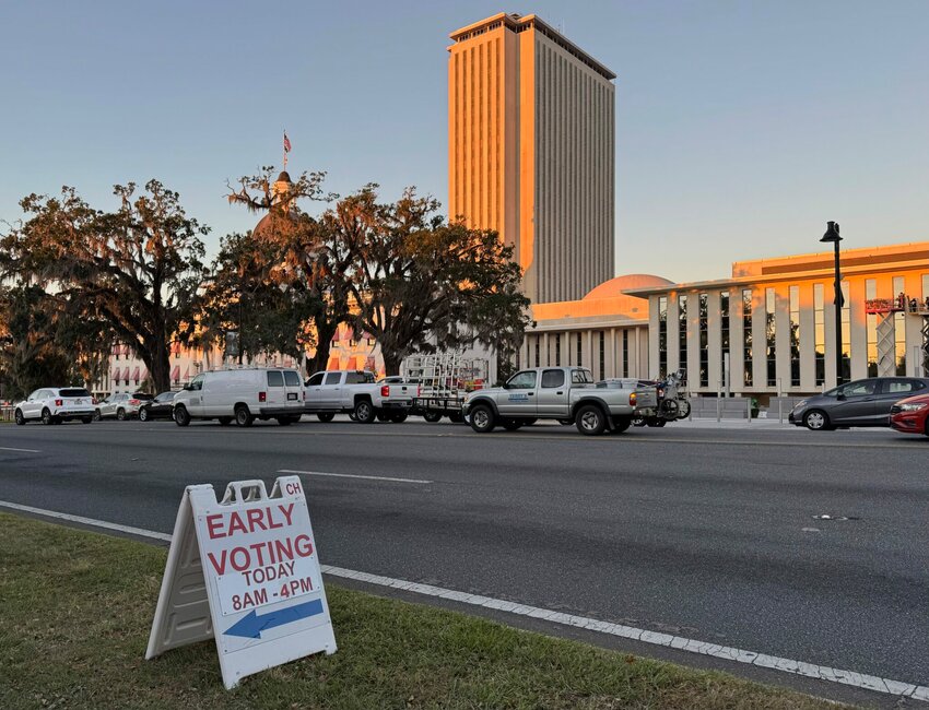 Floridians began early voting in most Florida counties on Oct. 21, 2024. The Florida Capitol stands in the background of an early voting sign at the Leon County Courthouse.