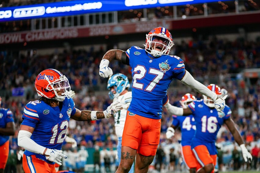 University of Florida cornerback Dijon Johnson (27) and safety D.J. Douglas (12) celebrate a big play in the Gasparilla Bowl against Tulane University in Tampa, Fla. on Dec. 20, 2024.