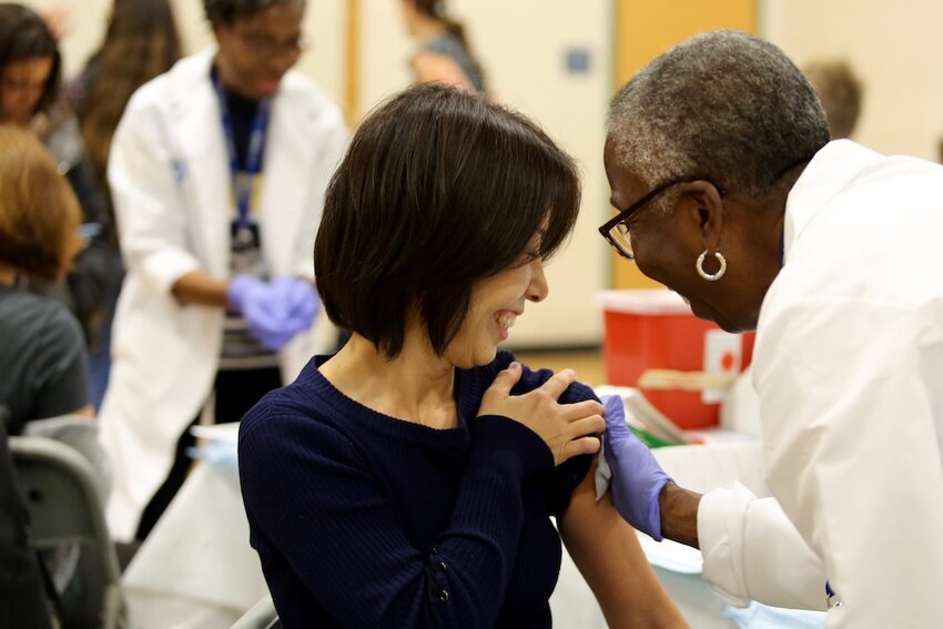 A woman receives a flu vaccination at a recent clinic in Cambridge, Mass., conducted by health care providers from the Cambridge Health Alliance. Flu-related deaths are at a seven-year high as vaccination levels fall, according to a Stateline analysis.