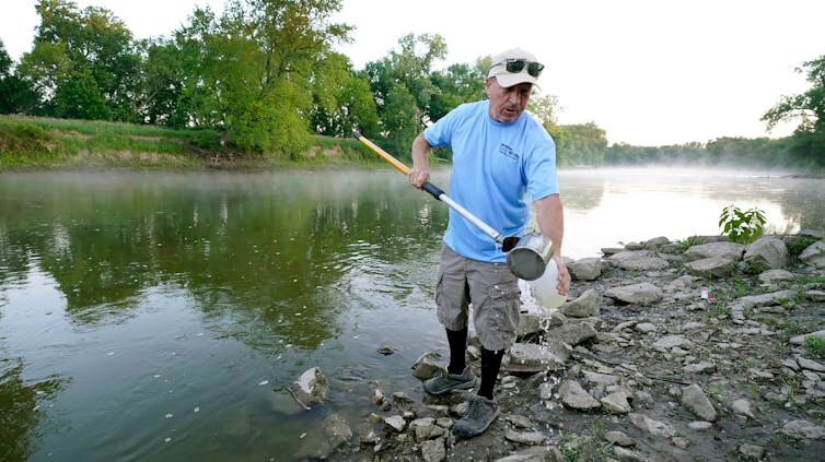 A Des Moines Water Works employee analyzes samples from a nearby river. The regional water utility delivers drinking water to more than 500,000 Iowans.