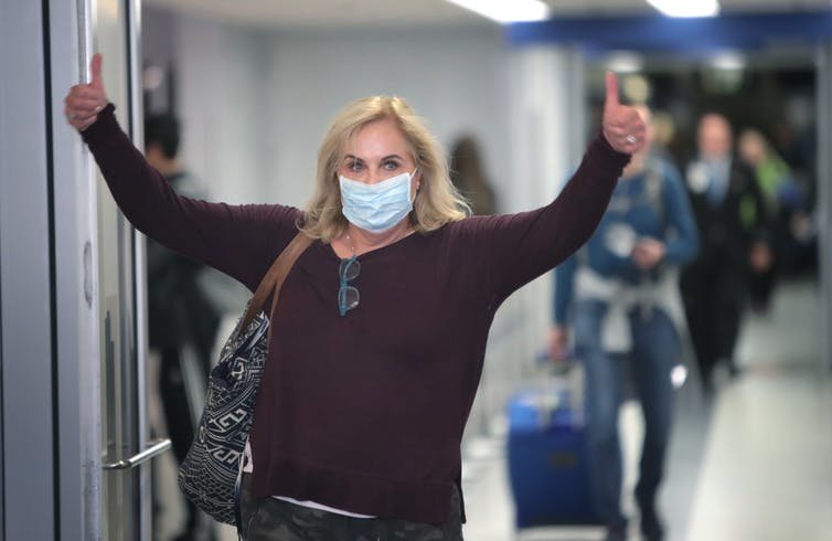 A woman at O'Hare International Airport in Chicago gives the thumbs-up upon arrival from an overseas flight.
Getty Images / Scott Olson