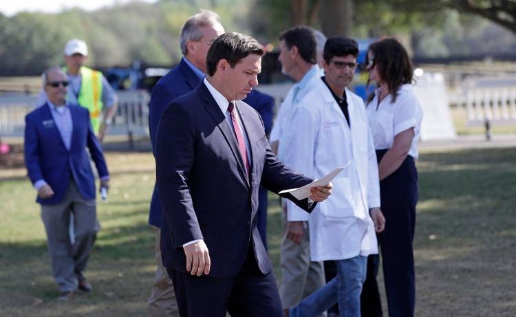 Florida Gov. Ron DeSantis arrives at a mobile testing site for a news conference Monday, March 23, 2020, in The Villages, Fla. John Raoux / AP