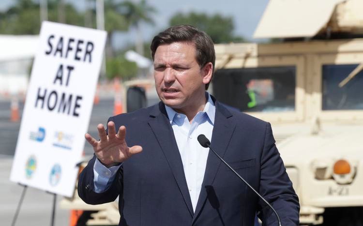 Florida Gov. Ron DeSantis speaks during a news conference at a drive-thru coronavirus testing site in front of Hard Rock Stadium on Monday, March 30, 2020, in Miami Gardens, Fla.