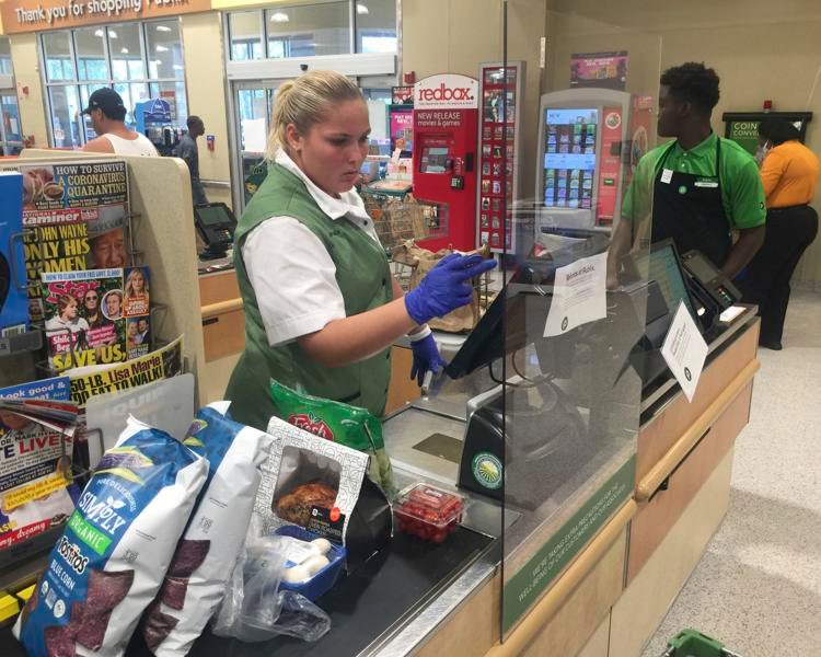 Publix supermarket has installed protective shields at its checkout registers to combat the spread of COVID-19, as seen in this Coconut Creek, Fla., store Wednesday, April 1, 2020. mpi04/MediaPunch/IPX via AP