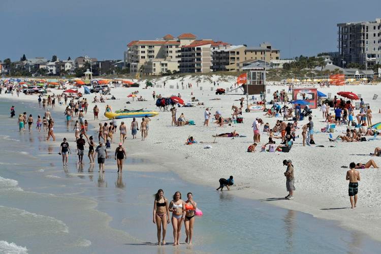 Visitors enjoy Clearwater Beach on Wednesday, March 18, 2020, in Clearwater Beach, Fla. 
Chris O'Meara / AP