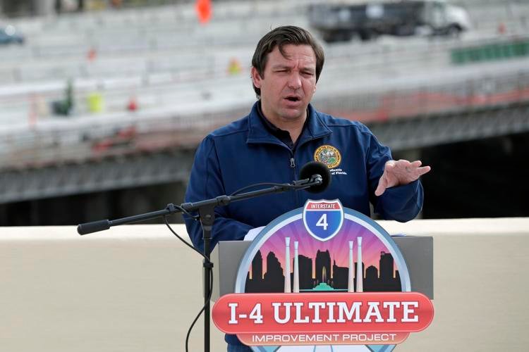 Florida Gov. Ron DeSantis speaks at a news conference Monday, May 18, 2020, in Orlando, Fla. The governor announced the I-4 and State Road 408 interchange has opened and because of less traffic due to the coronavirus pandemic, workers were able to expedite the workflow on the I-4 Ultimate Project. John Raoux / AP