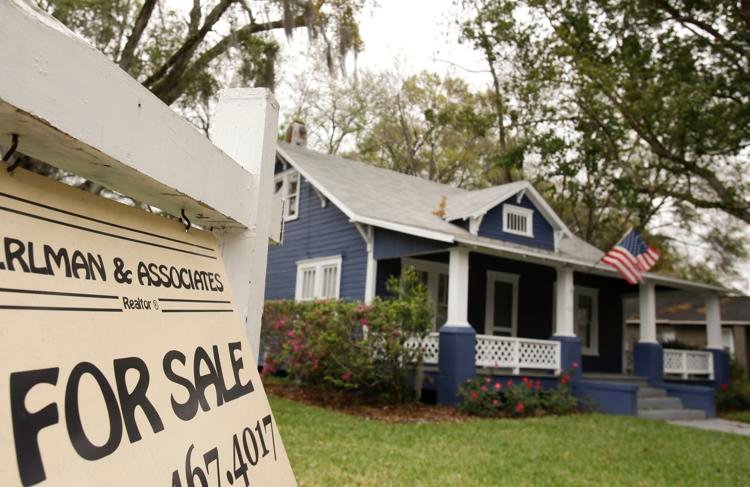 A for sale sign hangs in front of a home for sale in Orlando, Fla. John Raoux / AP