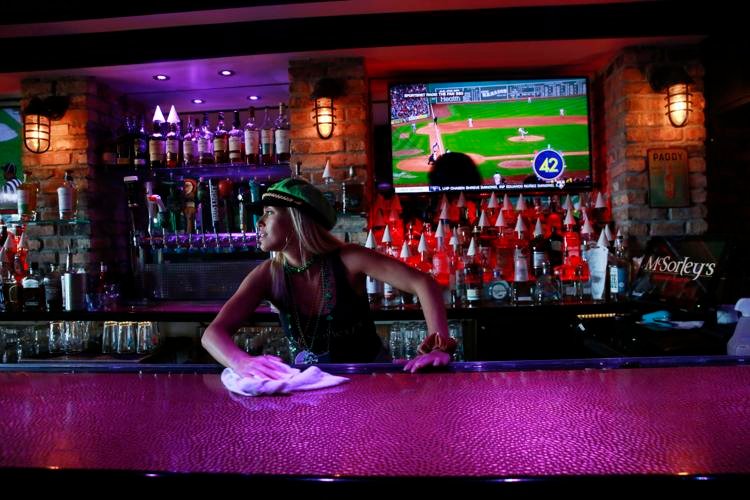 Kelli Rizza cleans the bar Brynn Anderson / AP