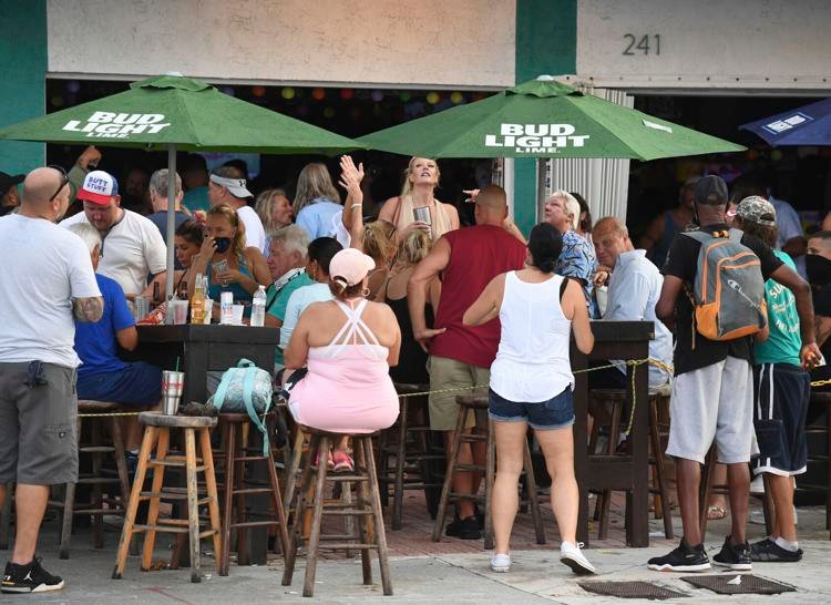People seen partying Saturday, Sept. 26, 2020, at the Elbo Room in Fort Lauderdale, Fla., after Gov. Ron DeSantis announced Florida was moving to phase three of its reopening plan, with bars and restaurants opened at full capacity. mpi04/MediaPunch / AP