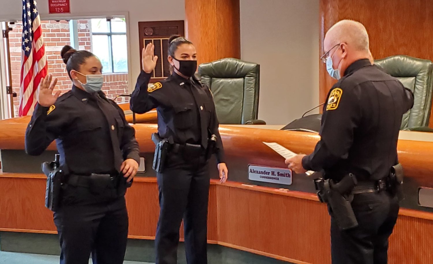 Apopka Police Chief Michael McKinley swearing in new officers Liana Marie Espaillat and Lauren Bordeaux