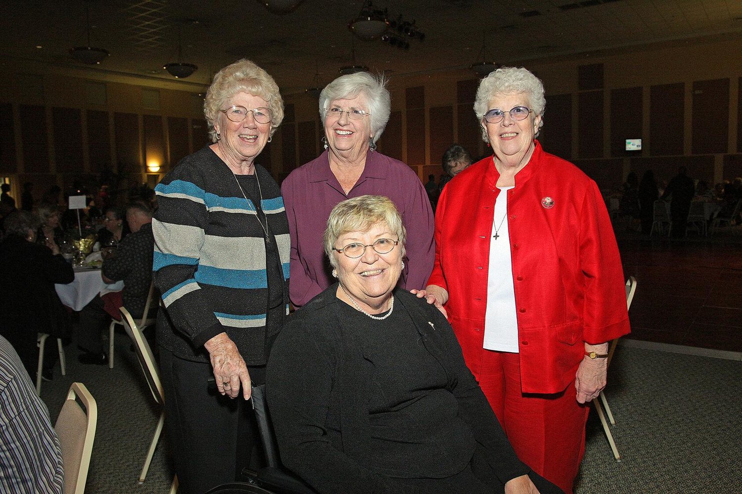 Sisters of Notre Dame de Namur pose for a photo during a farmworkers fundraiser in Maitland. Front center is Sister Cathy Gorman. In the back row, left to right, are Sisters Teresa McElwee, Ann Kendrick and Gail Grimes. (CHARLES HODGES | FC)