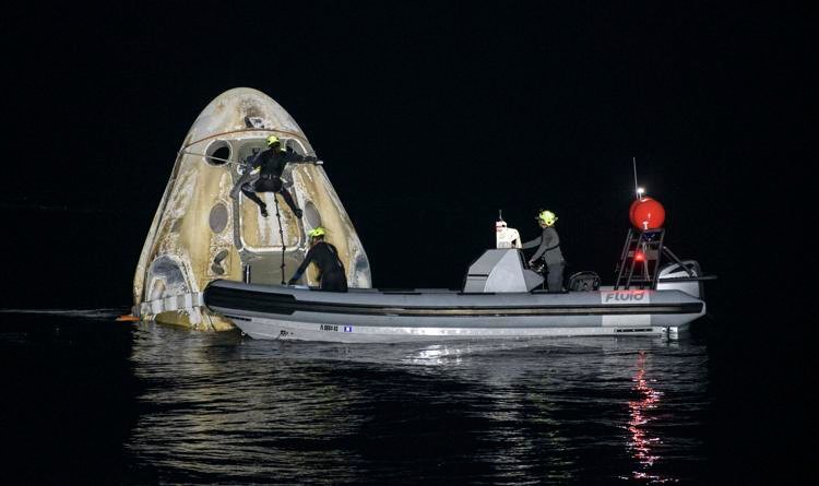Support teams work around the SpaceX Crew Dragon Resilience spacecraft shortly after it landed with NASA astronauts Mike Hopkins, Shannon Walker, and Victor Glover, and Japan Aerospace Exploration Agency (JAXA) astronaut Soichi Noguchi aboard in the Gulf of Mexico off the coast of Panama City, Florida, Sunday, May 2, 2021. NASA's SpaceX Crew-1 mission was the first crew rotation flight of the SpaceX Crew Dragon spacecraft and Falcon 9 rocket with astronauts to the International Space Station as part of the agency's Commercial Crew Program. Bill Ingalls/NASA via AP