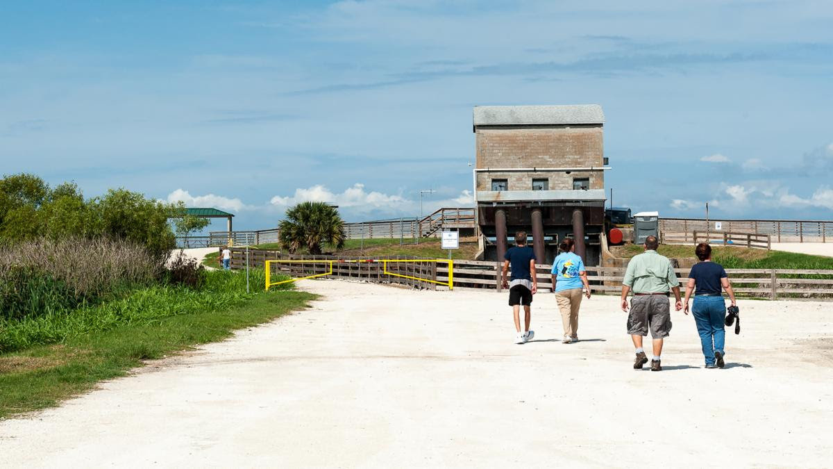Visitors walk toward the historic pumphouse at the District’s Lake Apopka North Shore property.