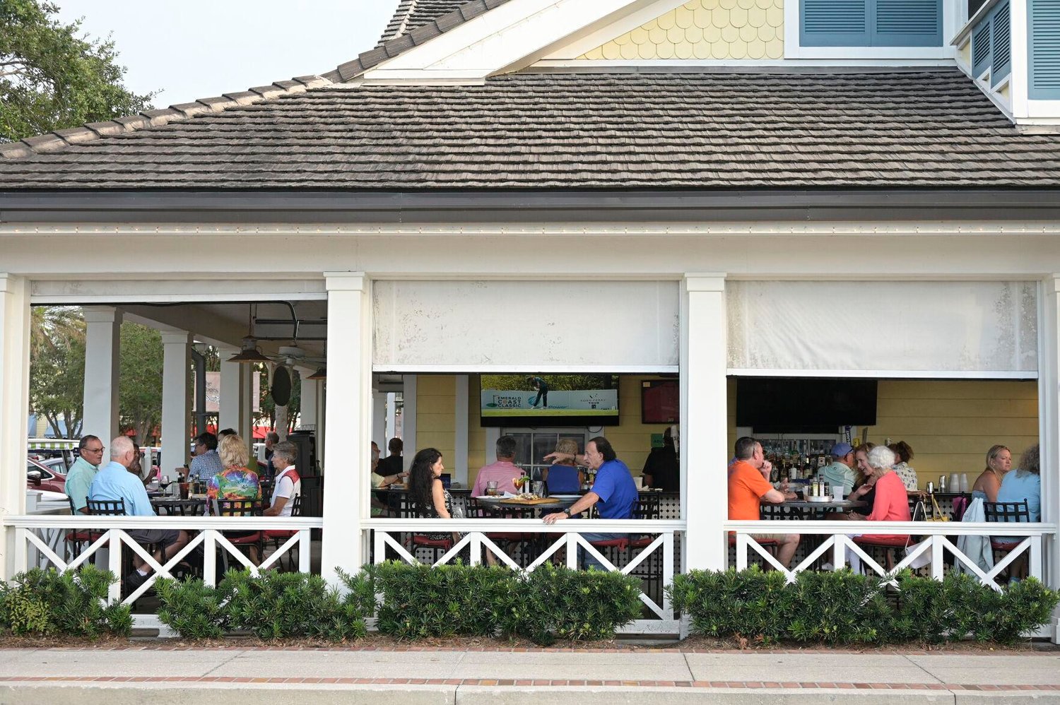 People sit in an outdoor dining area of a restaurant in the Lake Sumter Landing Market Square, Thursday, Aug. 12, 2021, in The Villages, Fla. 
AP Photo/Phelan M. Ebenhack