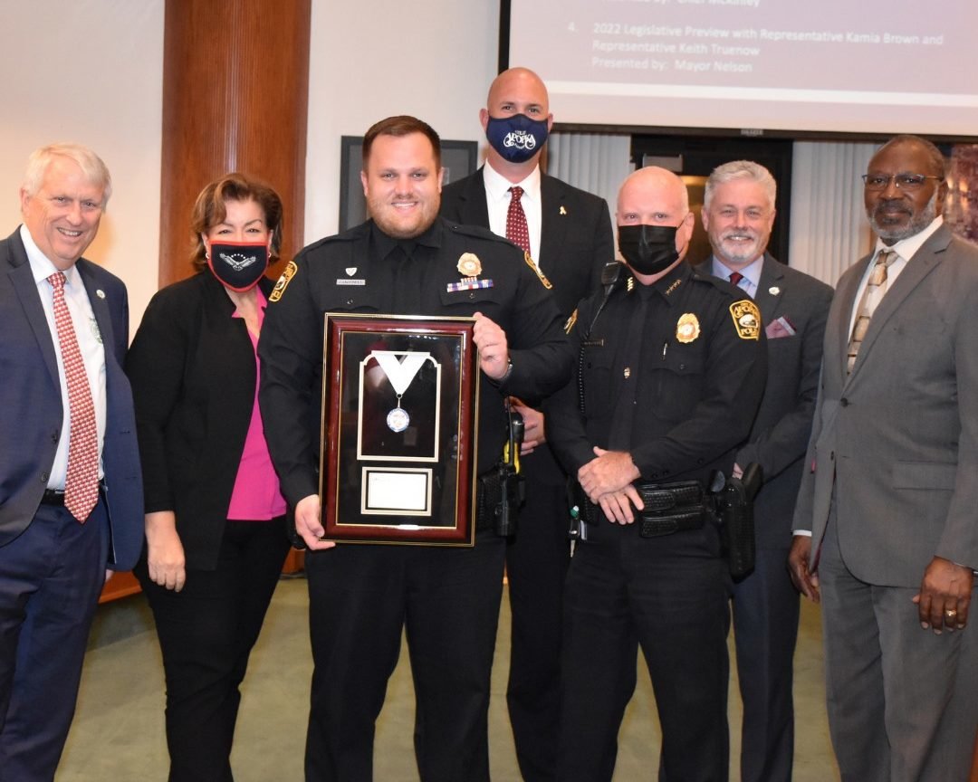 APD Officer Robert Campbell (third from the left) receives his award at the September 8th City Council meeting.