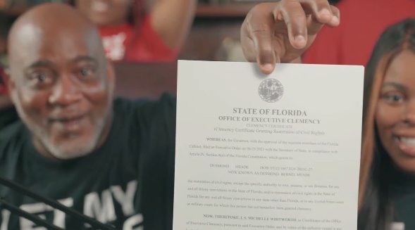 Desmond Meade shows off a copy of his clemency certificate during a Twitter streaming appearance on Oct. 9, 2021.