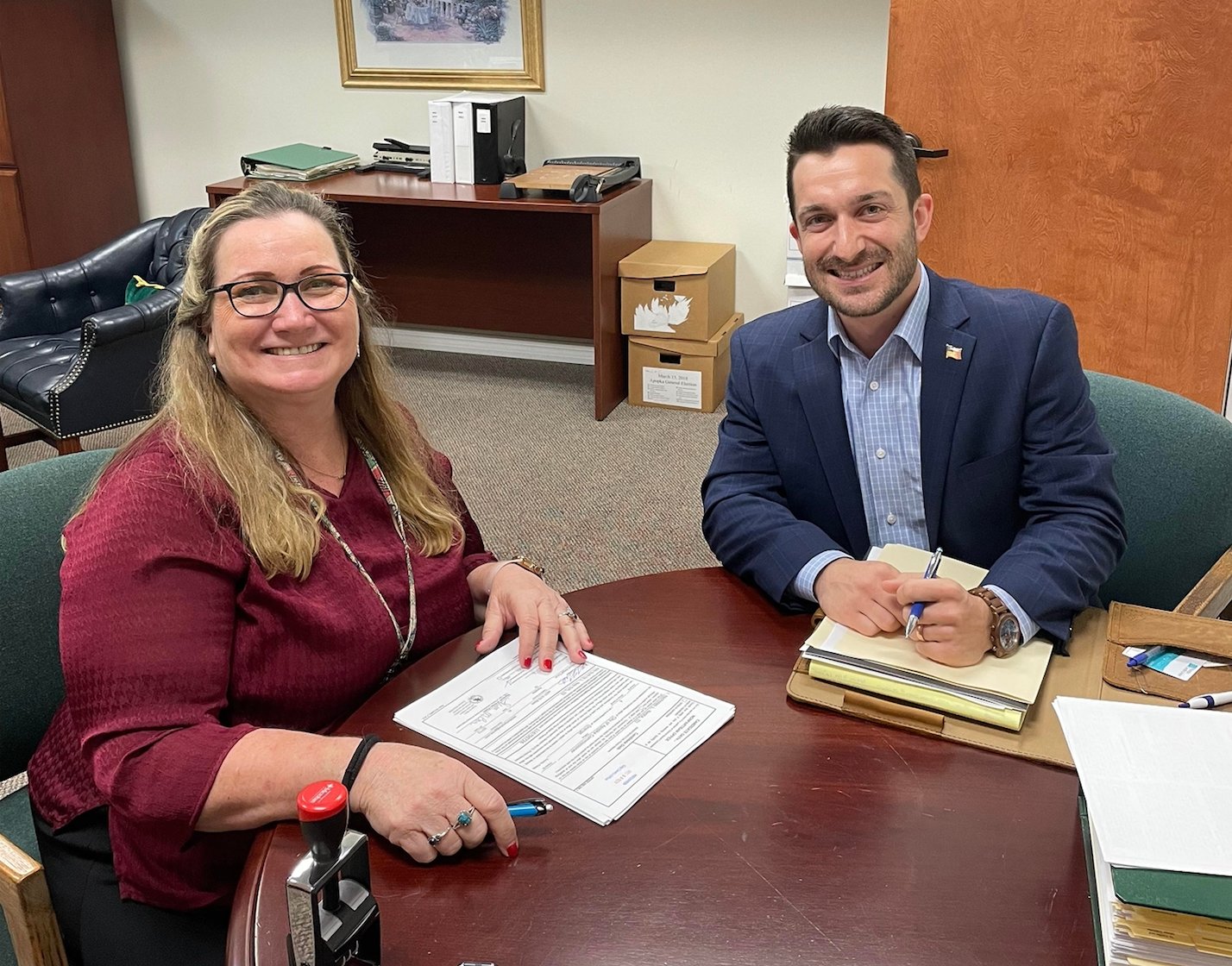 City Clerk Susan Bone (left) assists Nick Nesta (right) with his application to run in the Apopka City Commission election for Seat #4.