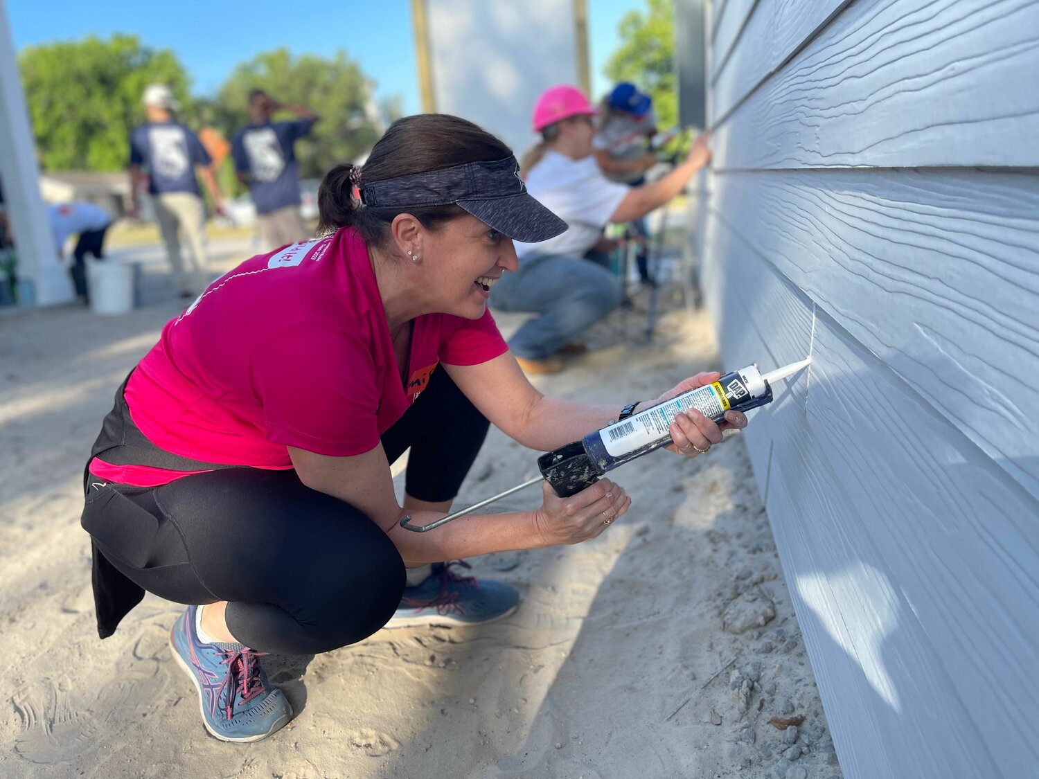 Jennifer Finfrock adds the sealing at the Women's Build event for the Seminole/Apopka Habitat for Humanity.