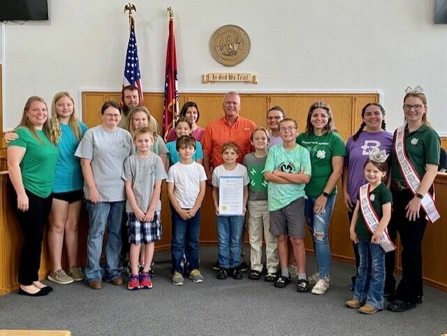 Baxter County Judge Kevin Litty (center) is joined by Baxter County 4-H club members and advisors during a ceremony declaring this week as National 4-H week.   Submitted Photo