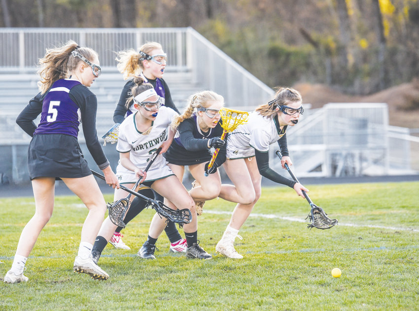 Northwood's Kendall Laberge (right) and Nailah Robertson (2) battle for a loose ball in Pittsboro versus Carrboro. It was the first-ever girls lacrosse game for Northwood.