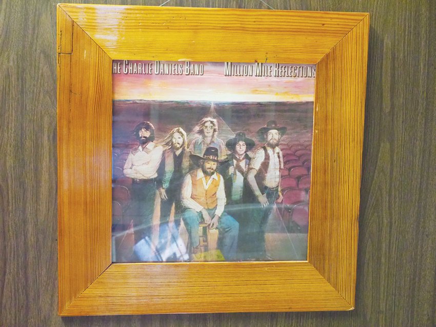 A copy of the Charlie Daniels Band's album 'Million Mile Reflections,' which is best known for the hit single 'The Devil Went Down to Georgia,' is framed at JR Moore & Son in Gulf.