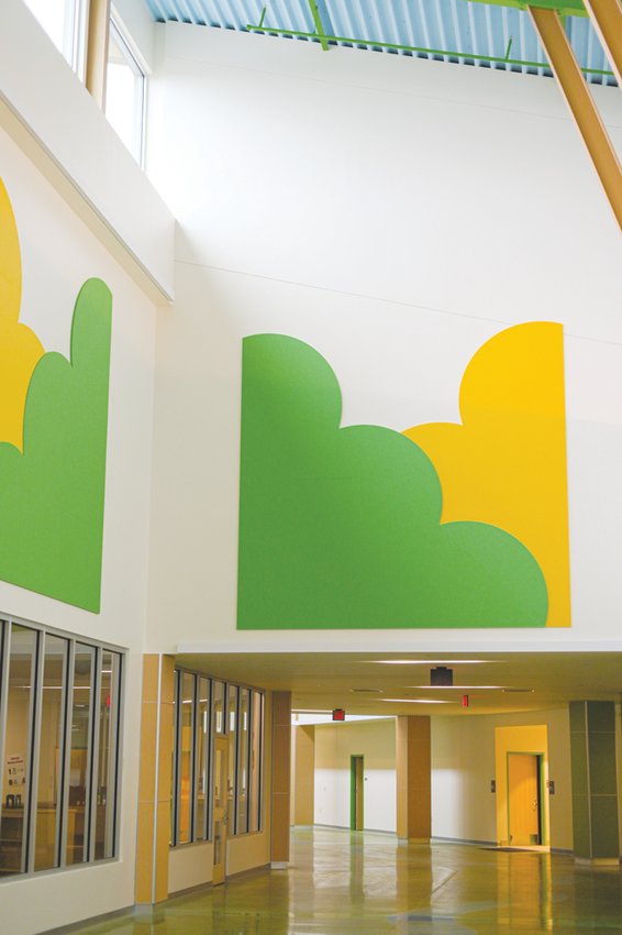 The school had acoustical panels — cut in the shape of clouds —installed to keep the noise down in the school’s hallways. The lobby is designed with a forest canopy theme.