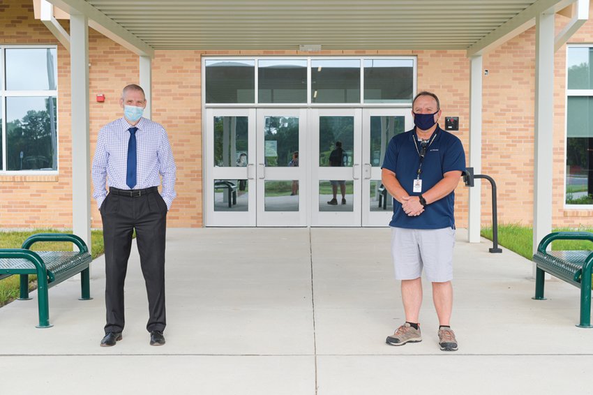 CCS Director of Maintenance and Construction Randy Drumheller (right, posing with Principal Larry Savage) said the building’s construction was not delayed at all by the pandemic.