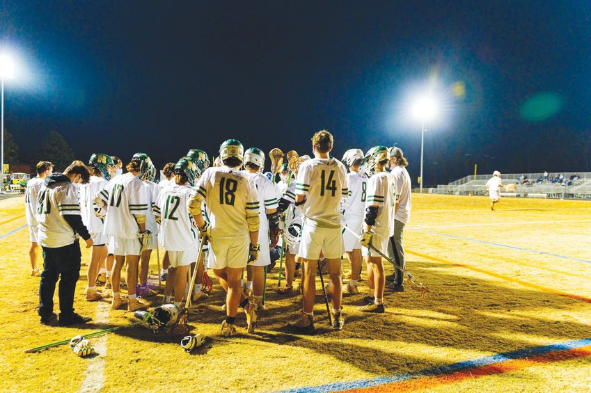 Northwood's men's lacrosse team gathers in a huddle after the team's 17-6 blowout win over Carrboro on March 9.