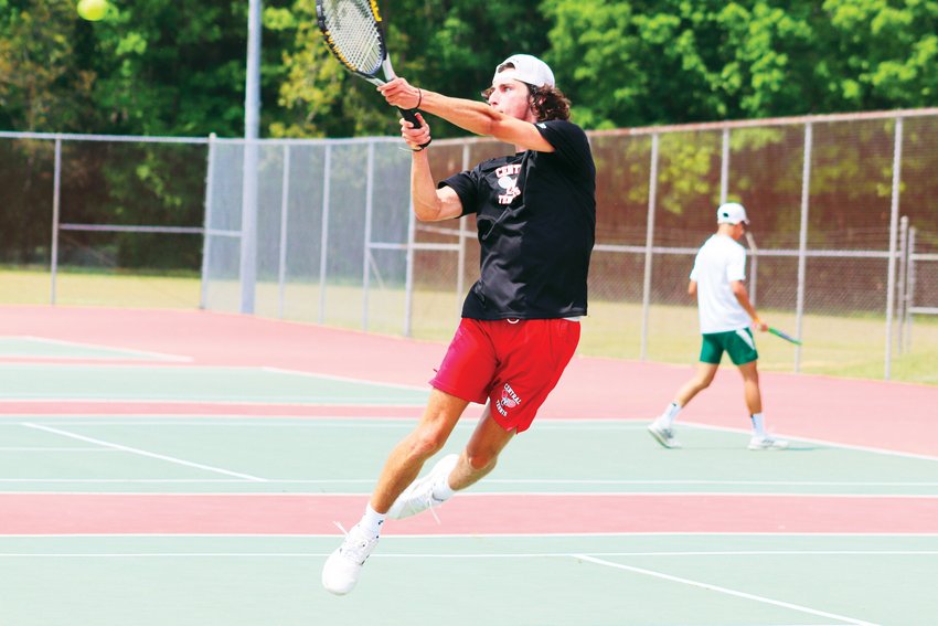 Chatham Central junior Colby Williamson flies into the air for a point during his singles semifinals match in the Yadkin Valley Conference Tournament.